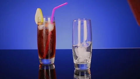 Couples Iced Tea Glasses on Reflecting Table Stock Footage 79586020