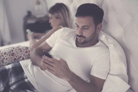 Couples issues with technology addiction Stock Photos