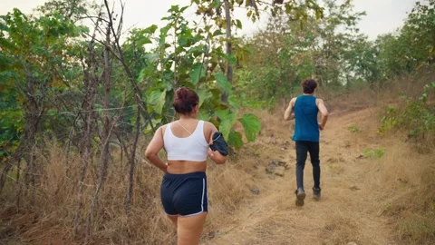 Couples jogging by forest track Stock Footage 298236142
