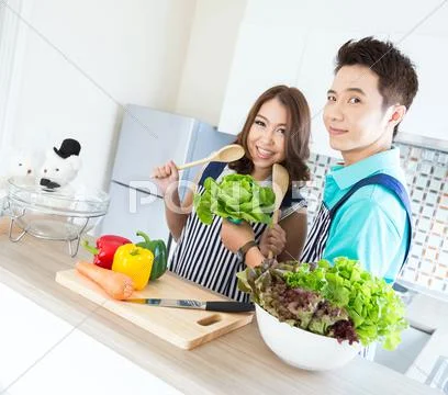 Couples in modern kitchen Stock Photos