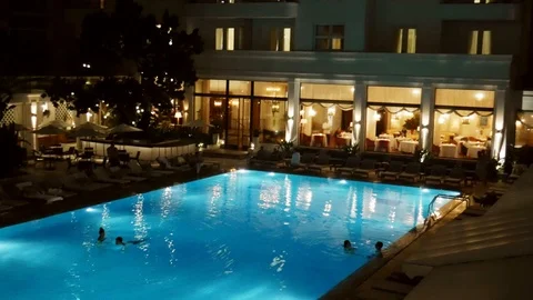 Couples relax at a swimming pool within the luxurious Copacabana Palace, Rio de Stock Footage 104866884