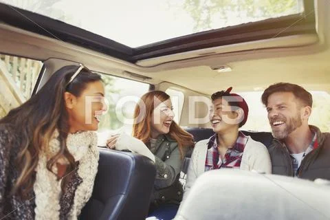 Couples riding and laughing in car Stock Photos