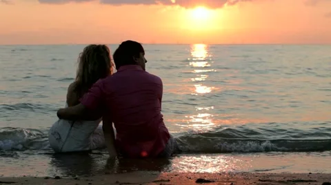 Couples Sit On The Beach Video stock 52695579