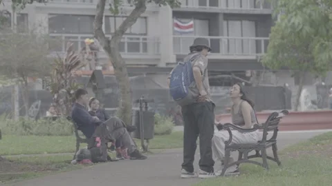Couples sitting on a bench in San José, Costa Rica, during the day Stock Footage 344339281