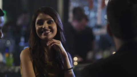 Couples at a table in a club having a drinks and talking with each other Stockbeeldmateriaal 34006159