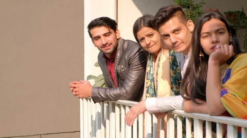 Couples talk to someone off camera at terrace balcony at leave walk out of their Stock Footage 101225264