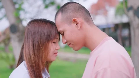 Couples touch foreheads and go outside for love and marriage. Living together  Stock Footage 265229653