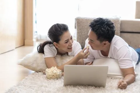 Couples using laptop bedroom Stock Photos