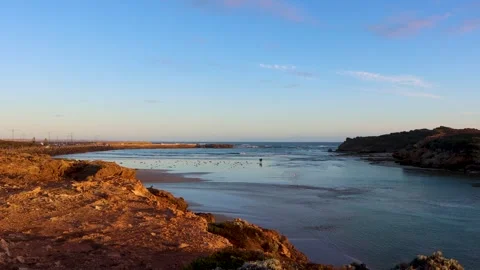 Couples walking along the beach during evening time around the sunset. Stock Footage 292498052