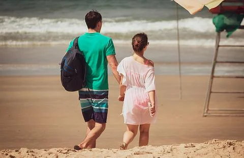 Couples walking on the Beach Stock Photos