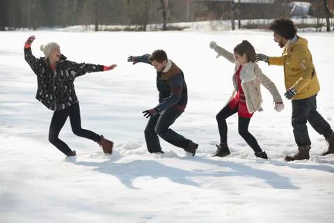 Couples walking in snow Stock Photos