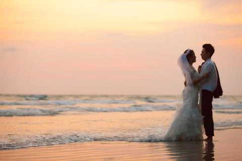 Couples wedding beach sunset Stock Photos