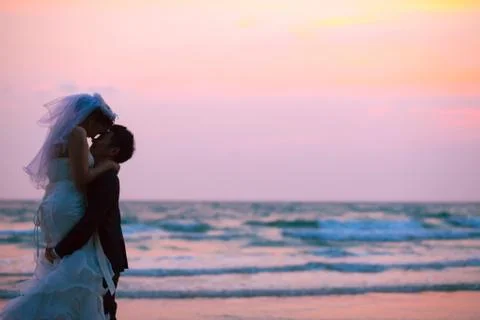 Couples wedding beach sunset Stock Photos