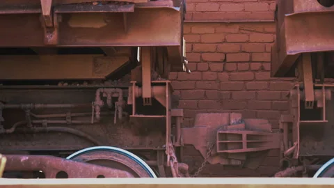 Coupling railway carriage for linking freight train wagon against the red brick Stock Footage 87733381