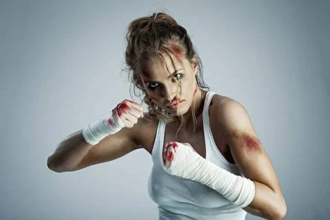 Courage has no sex. A photo of woman standing in fight position with blood... Stock Photos