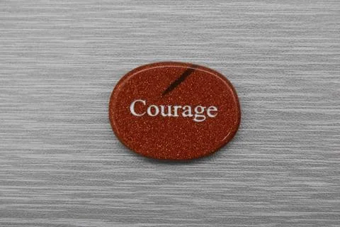 Courage mood stone, on gray background Stock Photos