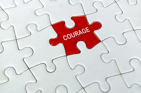 COURAGE, Single red courage puzzle piece positioned alone in the center of .. Stock Photos