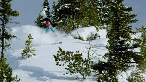 Courageous skier skiing down the slope of a snow covered mountain during winter Stock Footage 116631515