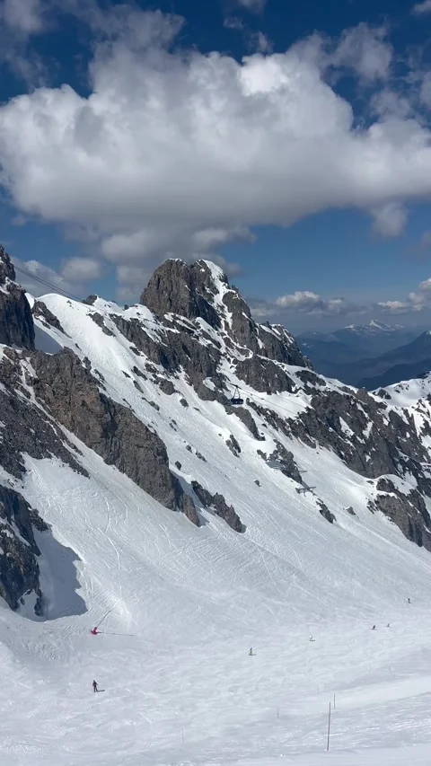 Courchevel ski resort with cable car carrying skiers to the peak of Saulire Stock Footage 334441970