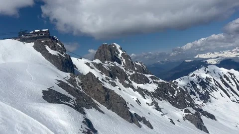 Courchevel ski resort with cable car carrying skiers to the peak of Saulire Stock Footage 334442178