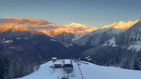 Courchevel ski resort by sunset time with trees covered under snow Stock Footage 337195775
