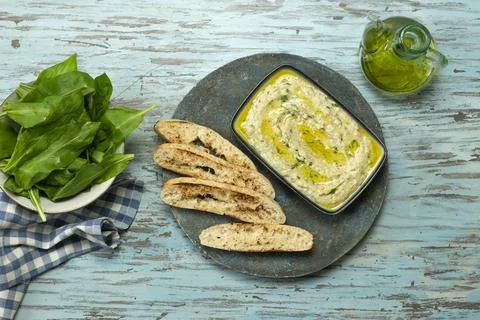 Courgette and white bean dip, served on the table. Stock Photos