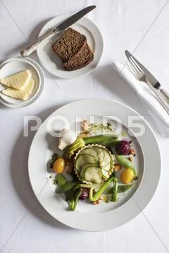 Courgette tartlet with steamed vegetables Stock Photos