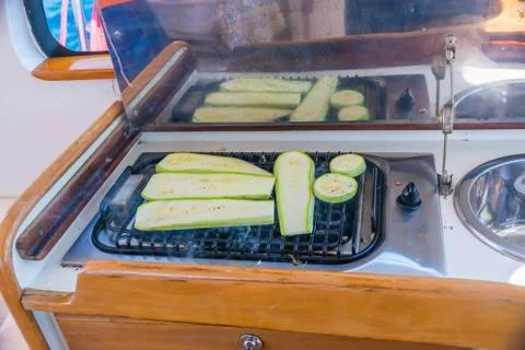 Courgettes zucchini are fried while sailing on a yacht. Stock-Fotos