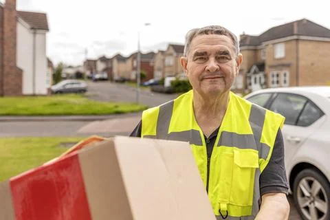 Courier Approaching Home While Carrying Online Shopping Parcel for Delivery Stock Photos