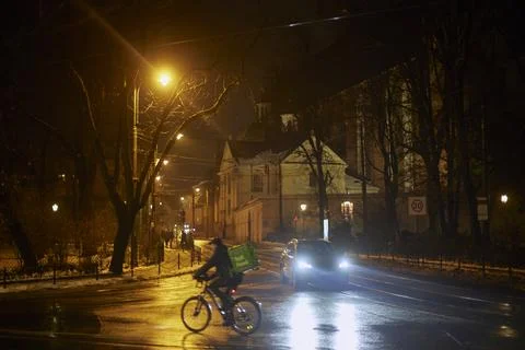 Courier on a bicycle on a night road Stock Photos