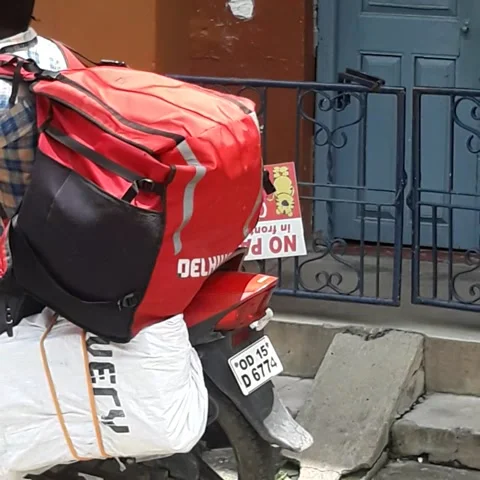 Courier boy delivers courier packets door to door on a motorcycle in India 스톡 동영상 239728444