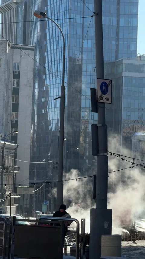 Courier carrying parcel through steam on winter city street Stock Footage 329488030