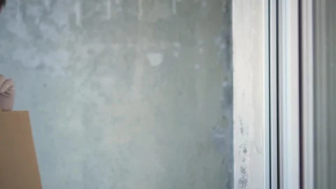 Courier is delivering the ordered products home to the customer during pandemic Stock Footage 127901538