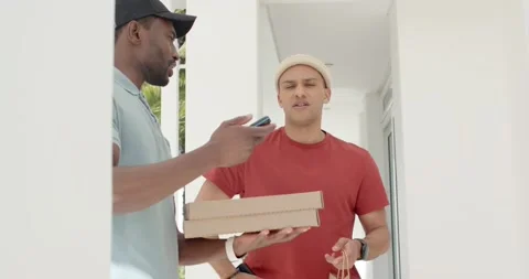 Courier delivering pizza boxes checking phone confirming with customer at door Stock Footage 340980632