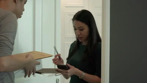 Courier Delivery Interaction in a Modern Setting Stock Footage 318863479