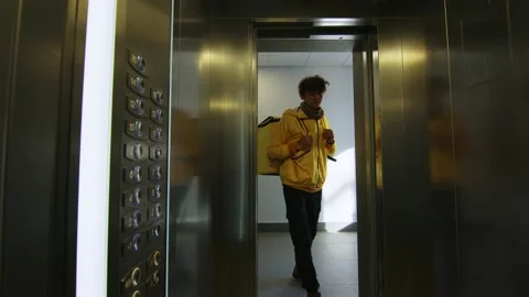 The courier enters the elevator Stock Footage 236898160