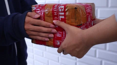 Courier gives parcel box labeled fragile to the customer Stock Footage 275872500