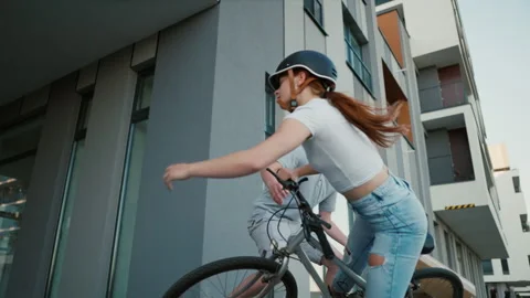 Courier guy with boxes knocks down from the bike young cyclist woman. Stock Footage 201149254