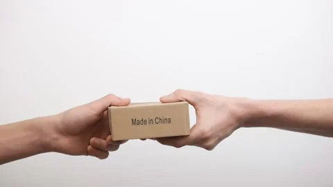 The courier hands over the package from China and shakes Stockbeeldmateriaal 150331986