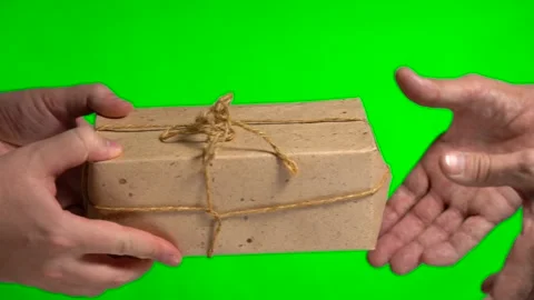 The courier hands over the parcel to the recipient on a green background Stock Footage 145128082