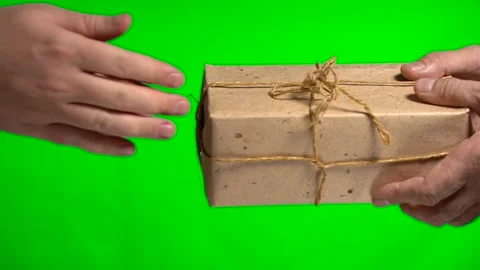The courier hands over the parcel to the recipient on a green background Stock Footage 146256882