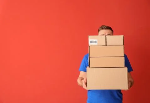 Courier Holding Stack of Delivery Boxes Stock Photos