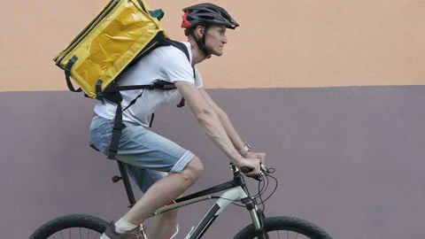 The courier makes delivery of the order to customers by bicycle. Stock Footage 134152994