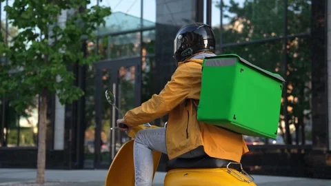 Courier man take delivery order by phone. Guy deliver food ride on scooter bike. Stock Footage 281553716