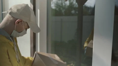 Courier Man Wearing Face Mask And Rubber Gloves Delivery Service Video stock 141764021