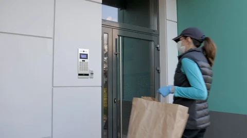 Courier In Mask Wearing Gloves Performs Delivery Of Food During Pandemic Virus Stock Footage 129703616