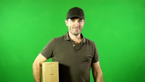 Courier with parcel / package smiling to the camera. Green screen Chroma key Video stock 131004846
