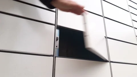 Courier Puts Cardboard Package Into Parcel Locker Stock Footage 144995386