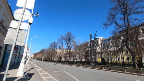 A courier rides a bicycle on an empty road in the center of Moscow. Stock Footage 129603242
