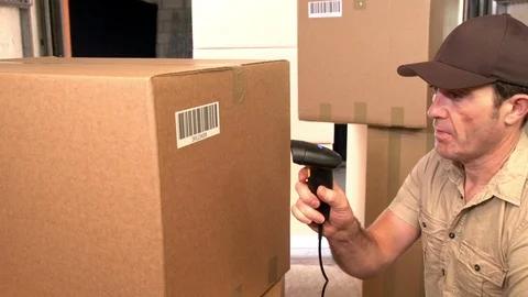 Courier scanning parcels / packages in the back of a  shipping truck. Bar code Stock Footage 125133162